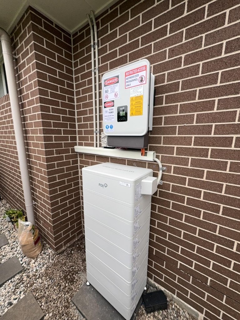 FoxESS battery and inverter installation on outdoor brick wall